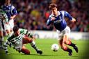Rangers hero Brian Laudrup skips past a despairing Brian O'Neil to score against Celtic in 1996.