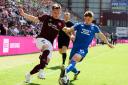 Lawrence Shankland and Robbie Fraser vie for possession at Tynecastle