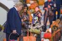 Donald Trump and first lady Melania Trump give candy to children during a Halloween trick-or-treat event