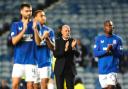 The manager and players clap the fans