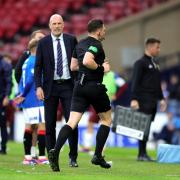 Referee Matthew MacDermid goes to the pitchside VAR monitor before awarding Rangers' their first goal of the game