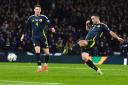 John McGinn, right, scores for Scotland against Croatia in the Nations League match against Croatia at Hampden tonight as his team mate Scott McTominay looks on