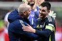 Andrew Robertson and Scotland manager Steve Clarke celebrate after the victory in Warsaw