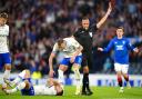 Rangers' Jefte (not pictured) is shown a red card by Marco Guida