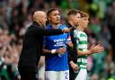 Rangers first-team coach Alex Rae (left) speaks with James Tavernier during the Scottish Premiership match against Celtic