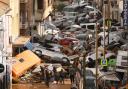 VALENCIA, SPAIN - OCTOBER 30: Cars are piled in the street with other debris after flash floods hit the region on October 30, 2024 in the Sedaví area of Valencia, Spain. Spanish authorities said on Wednesday that at least 62 people had died in the