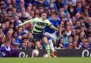 Manchester City's Phil Foden and Everton's Nathan Patterson (right) battle for the ball