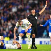 Rangers' Jefte (not pictured) is shown a red card by Marco Guida