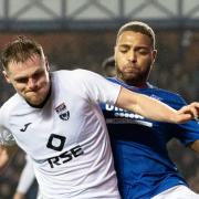 Cyriel Dessers and Josh Reid battle for the ball at Ibrox