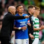 Rangers first-team coach Alex Rae (left) speaks with James Tavernier during the Scottish Premiership match against Celtic