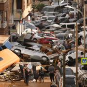 VALENCIA, SPAIN - OCTOBER 30: Cars are piled in the street with other debris after flash floods hit the region on October 30, 2024 in the Sedaví area of Valencia, Spain. Spanish authorities said on Wednesday that at least 62 people had died in the