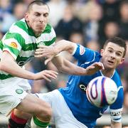 Ferguson and Brown contest a ball during an Old Firm derby