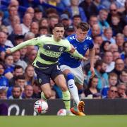 Manchester City's Phil Foden and Everton's Nathan Patterson (right) battle for the ball