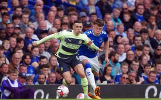 Manchester City's Phil Foden and Everton's Nathan Patterson (right) battle for the ball